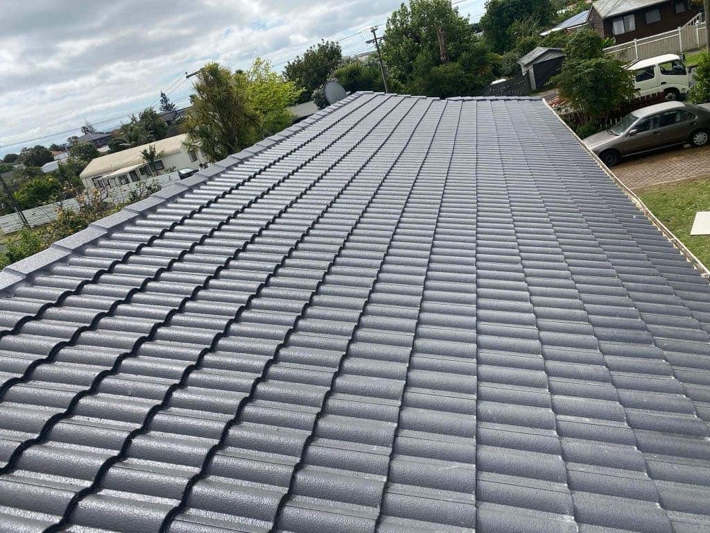 Auckland concrete tile roof after professional restoration by Willy Marsh Roofing